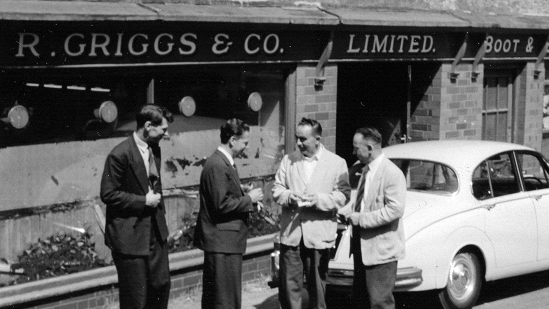 Owners of R. Griggs Group outside shop in 1950's